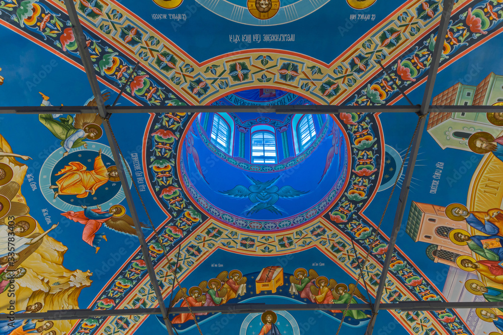 Eastern сhristian orthodox сhurch of Byzantine tradition. Traditional religious paintings and colorful  traceries on the ceiling.
