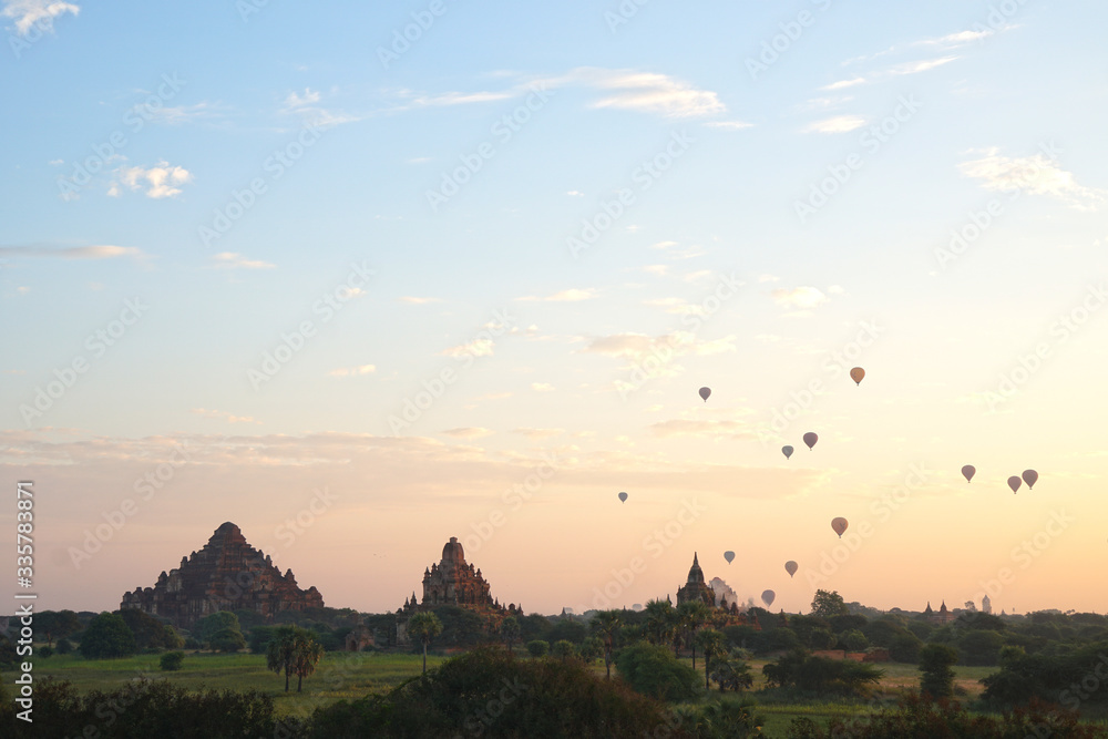 Landscape of ancient pagoda and balloon floating over the orange sky sunrise in the morning at Bagan , Mandalay , Myanmar - Scenery background