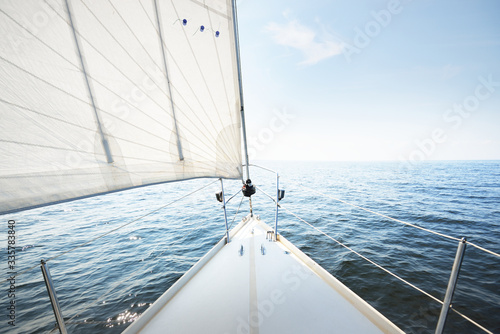 Bild auf Leinwand White yacht sailing on a sunny summer day