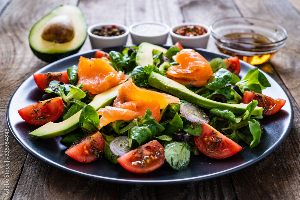 Salmon salad - smoked salmon and vegetables on wooden background
Salmon salad - smoked salmon and vegetables on wooden background