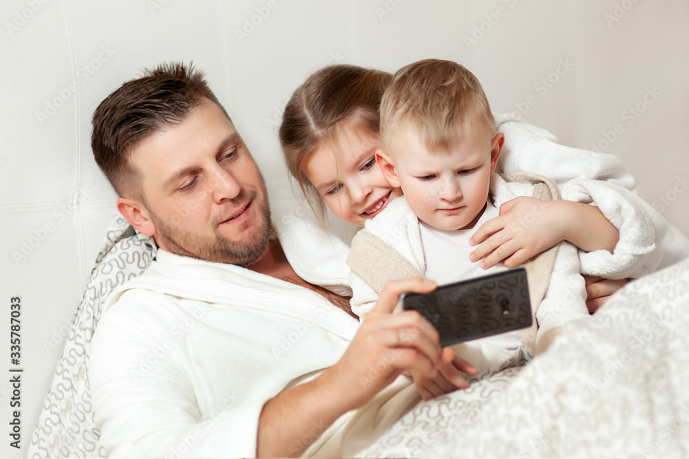 dad shows children interesting pictures in the phone dad shows children interesting pictures in the phone