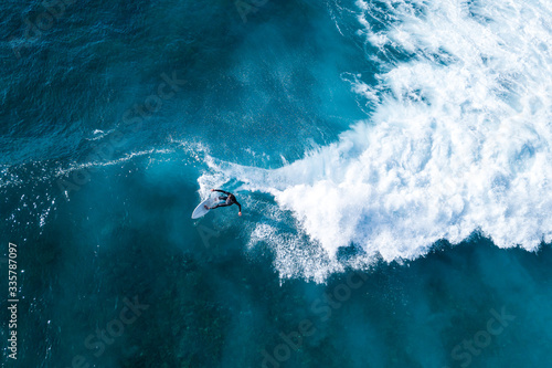 Surfer at the top of the wave photo