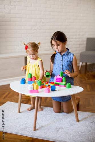 Two little girls play with ...