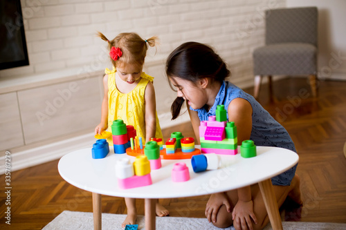 Two little girls play with ...