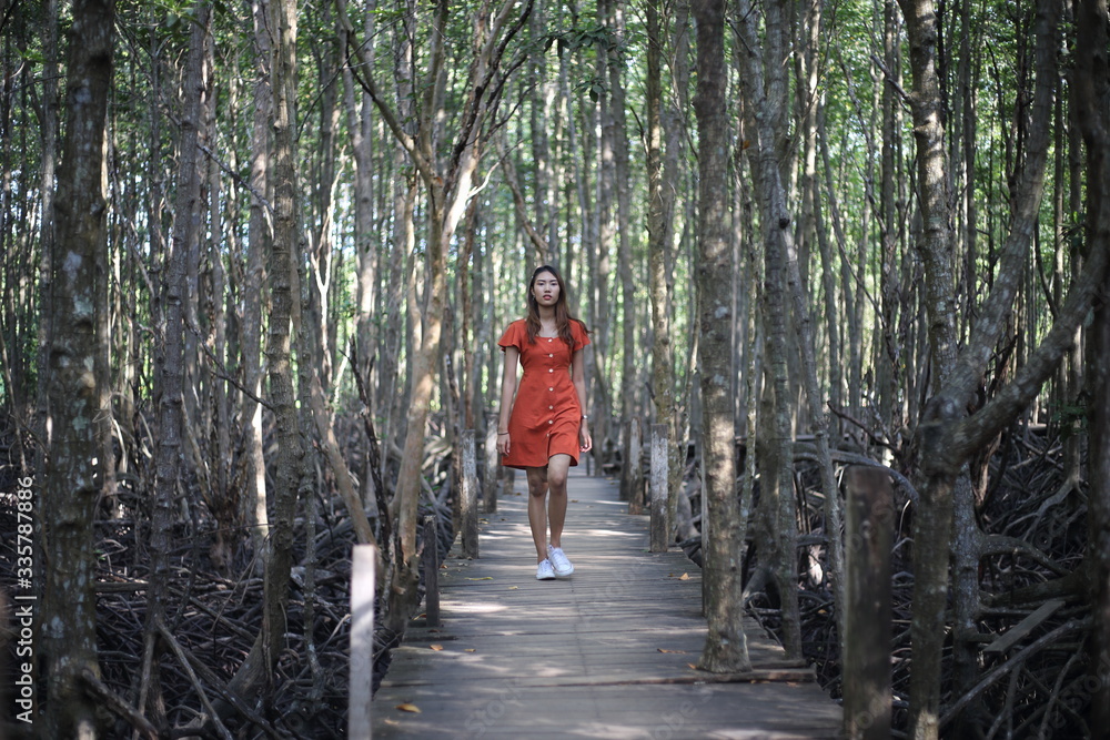 A woman standing at Tung Prong Thong at Rayong, Thailand A woman standing at Tung Prong Thong at Rayong, Thailand