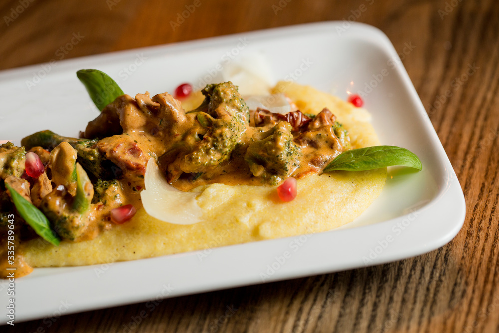 Turkey meat strips in broccoli sauce and dried tomato with parmesan polenta Turkey meat strips in broccoli sauce and dried tomato with parmesan polenta