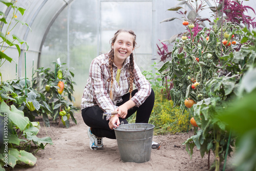girl working in   greenhouse