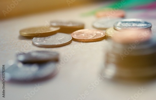The close-up group of a Thai coins placed on the floor selective focus and shallow depth of field.