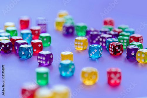 Colorful dice set on violet background