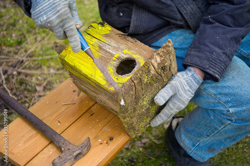 man fixing old birdhouse photo