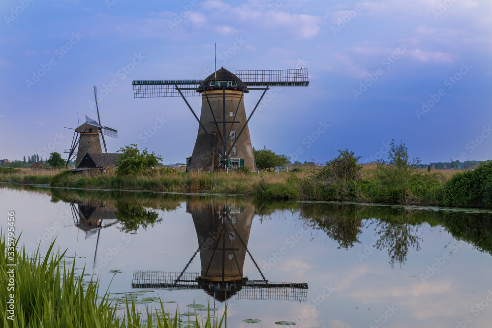 A windmill by a canal in Kinderdijk in the Netherlands