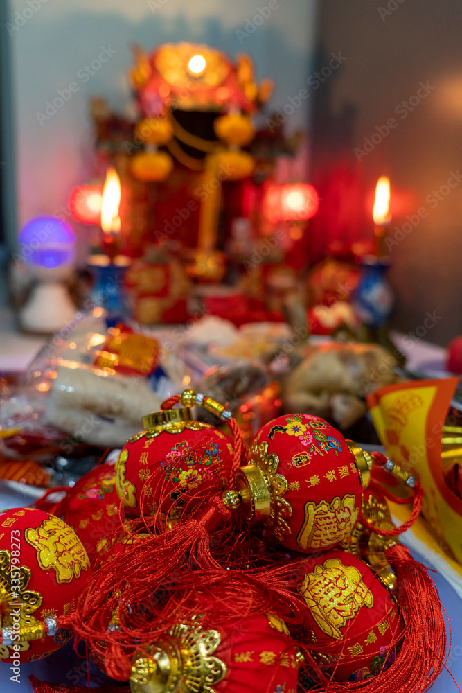 A small red lantern is placed in front of the shrine for Chinese New Year.