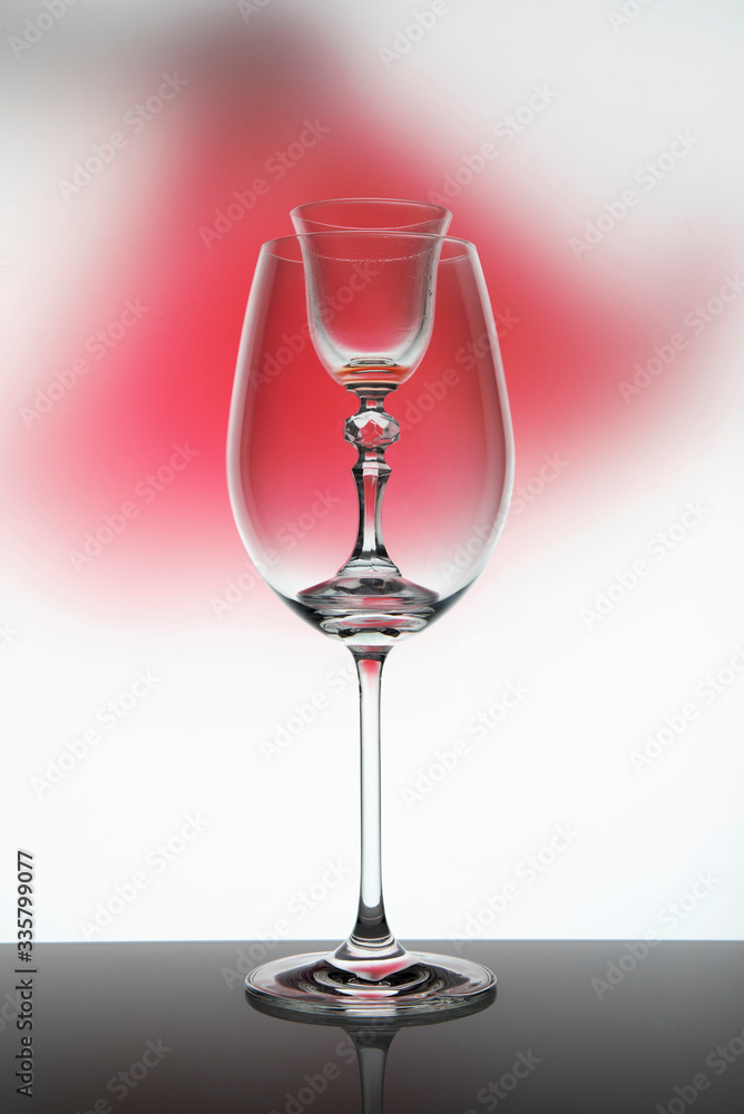 Two glass goblets on color gradient background
Two glass goblets on color gradient background