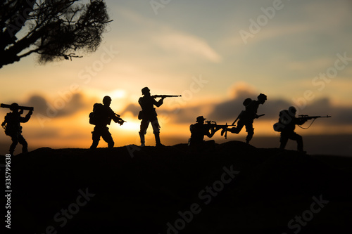 War Concept. Military silhouettes fighting scene on war fog sky background  World War Soldiers Silhouette Below Cloudy Skyline At sunset.