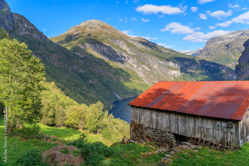 GEIRANGER, NORWAY - 2017 SEPTEMBER 03. Close to the most photographed waterfalls in Geirangerfjorden with 250 m impressive fall you will find the Norwegian abandoned farm named Knivsflaa.