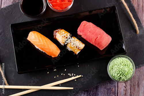 sushi with chopsticks on a black plate