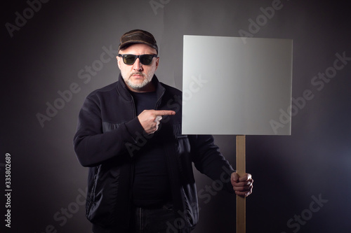 A man stands with a placard...