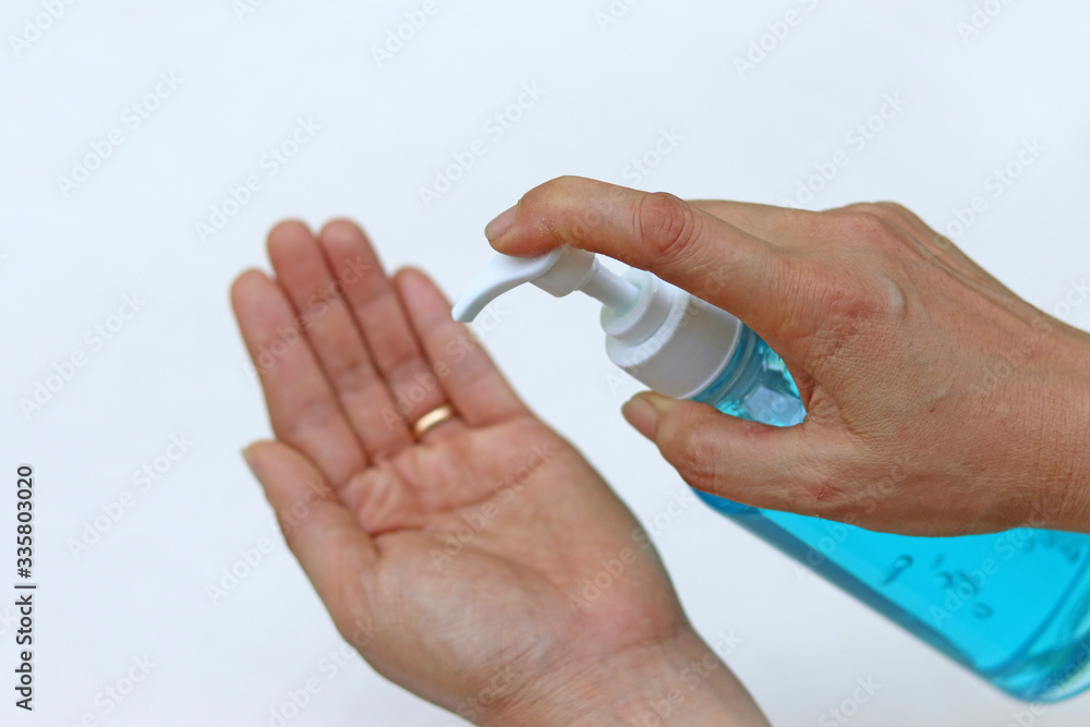 Female fingers pumping alcohol-based hand sanitizer gel on hand for killing germs, bacteria and virus. Disinfection concept of cleaning and washing hands with alcohol sanitizer. Female fingers pumping alcohol-based hand sanitizer gel on hand for killing germs, bacteria and virus. Disinfection concept of cleaning and washing hands with alcohol sanitizer.