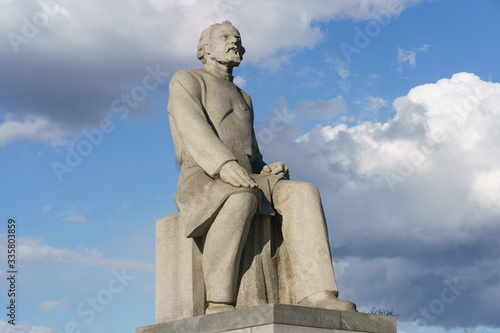 Photography the Monument to Konstantin Tsiolkovsky. Cosmonauts Alley near VDNH   VDNKH in spring day.  Silhouette of famous scientist in the high blue sky among clouds.