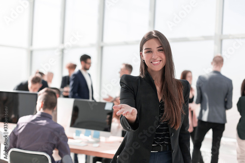 smiling friendly business woman on the background of the office.