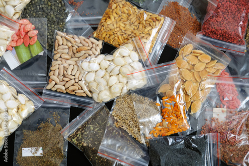 packaged in a variety of organic non-GMO seeds on a black background, creating a seed bank,