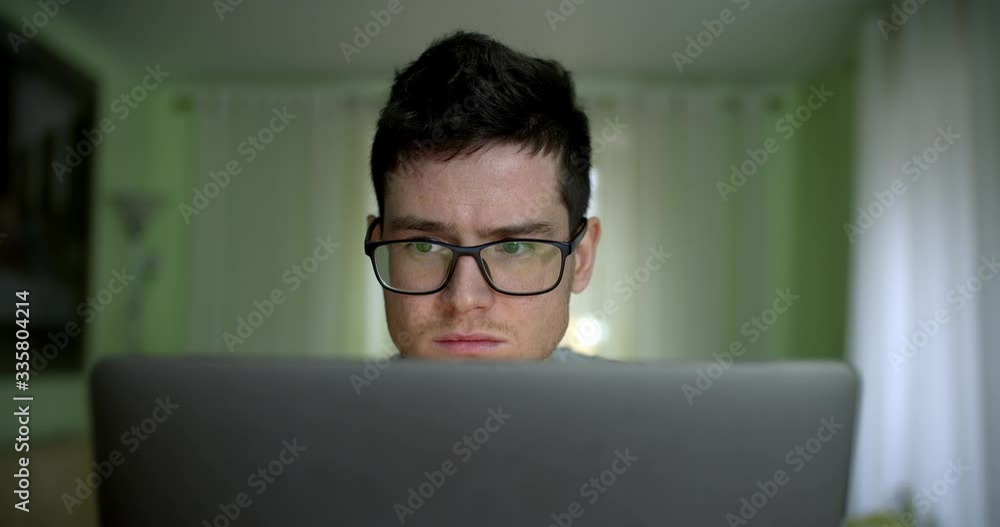 Working Remotely. Stay At Home! Close Up Portrait of concentrated Young man freelancer using laptop working online from home in internet, smiling millennial typing on computer surfing web Working Remotely. Stay At Home! Close Up Portrait of concentrated Young man freelancer using laptop working online from home in internet, smiling millennial typing on computer surfing web