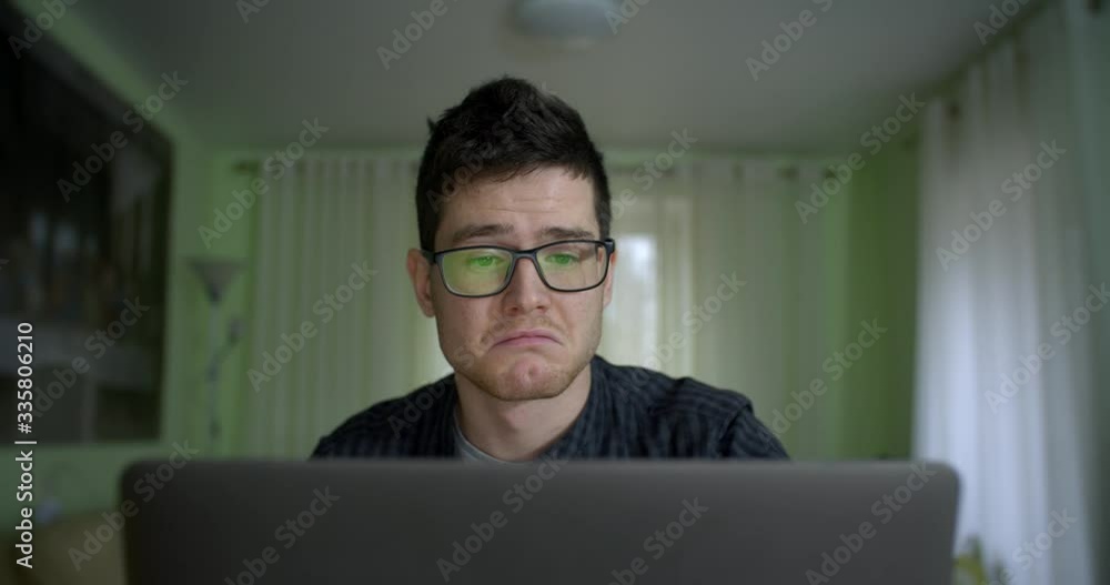 Working Remotely. Stay At Home! Close Up Portrait of Young man freelancer open laptop and starts remote work online during self isolation and quarantine Working Remotely. Stay At Home! Close Up Portrait of Young man freelancer open laptop and starts remote work online during self isolation and quarantine