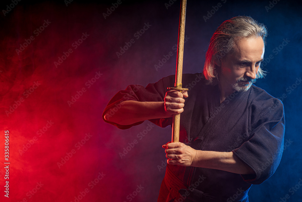 real caucasian mature kendo fighter ready to fight with enemy using bamboo sword shinai