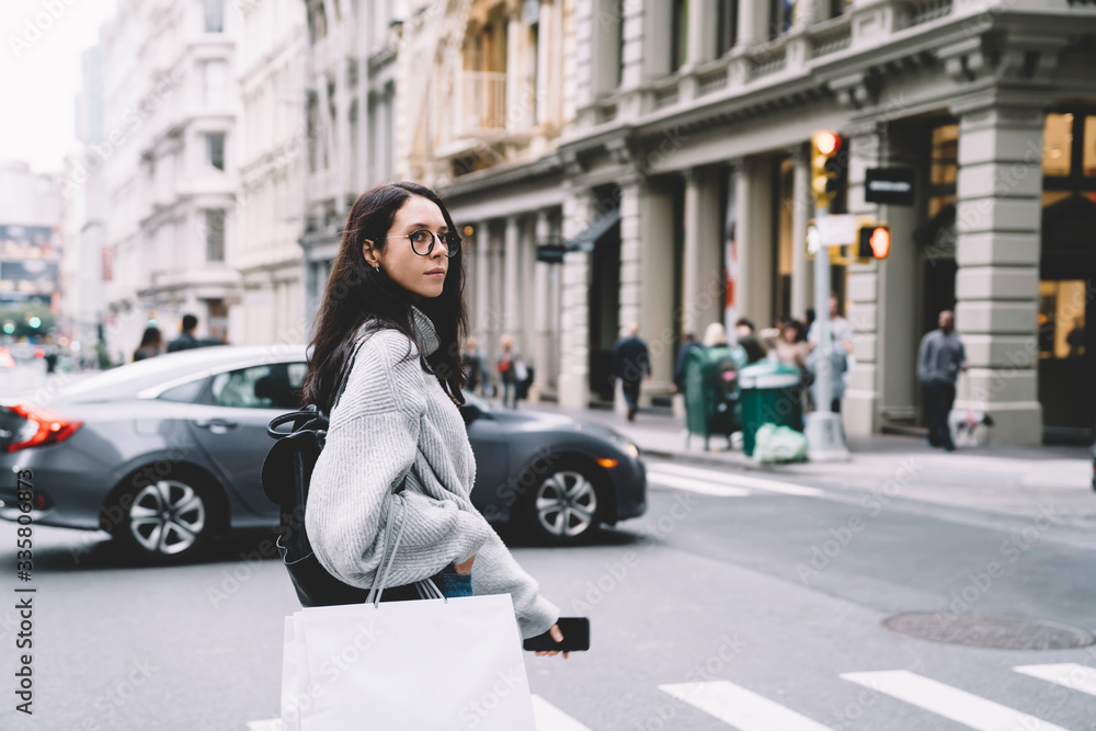Woman crossing street with shopping bags Woman crossing street with shopping bags
