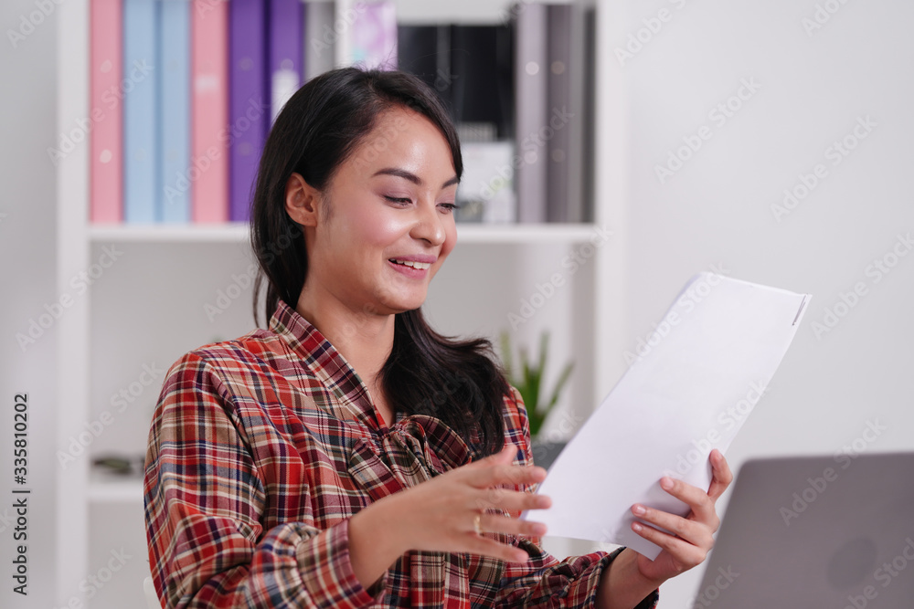 Happy excited Asian woman student reading letter with good news, get job opportunity, scholarship admission concept. business work opportunity for graduated student. Happy excited Asian woman student reading letter with good news, get job opportunity, scholarship admission concept. business work opportunity for graduated student.