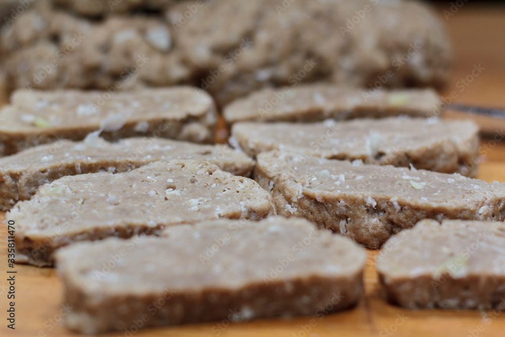 Homemade seitan slices on wooden board Homemade seitan slices on wooden board