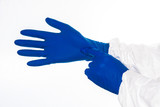 Doctor or nurse drawing on navy protection gloves on hands