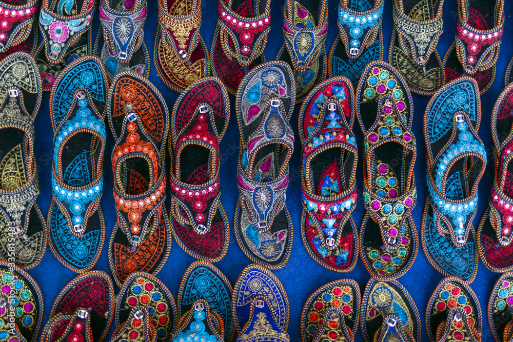 Kolhapuri Chappal- Colorful and variety of Ladies Ethnic Footwear displayed on sale at the street market in India. Kolhapuri Chappal in India are usually wore with Ethnic wear of Indian Culture.