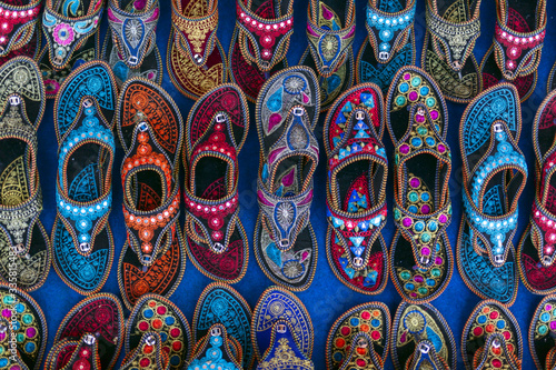 Kolhapuri Chappal- Colorful and variety of Ladies Ethnic Footwear displayed on sale at the street market in India. Kolhapuri Chappal in India are usually wore with Ethnic wear of Indian Culture. © minoandriani