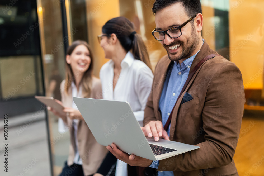 Business people discussing and smiling while walking together outdoor