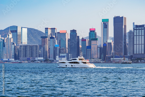 Prestige yacht by Hong Kong island at sunset time.