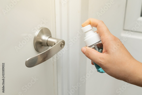 inject alcohol spray on door knob and frequently touched area for cleaning and disinfection, prevention of germs spreading during infections of COVID-19 coronavirus