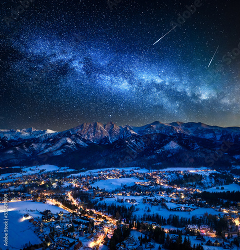 Fototapeta Naklejka Na Ścianę i Meble -  Illuminated Zakopane city in winter and milky way at night