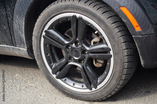 Car wheel close up. Big car wheel. Black big car wheel close up. Car tire close up