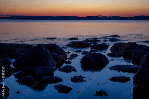 Sunset reflections among rocks in the Oslo Fjord. Taken from the beach below Refsnes Gods.