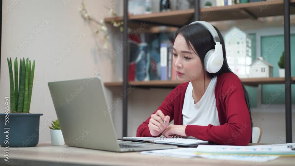 Young Asian female wear headset video chat job, Working at home Young Asian female wear headset video chat job, Working at home