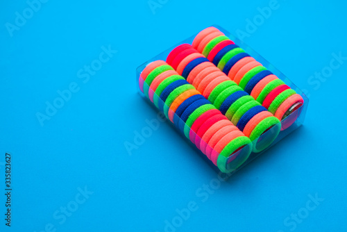 Colorful hair bands in a box on a blue background