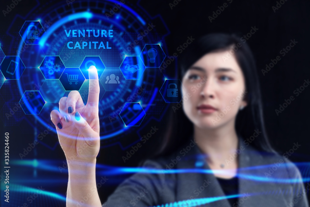 Business, Technology, Internet and network concept. Young businessman working on a virtual screen of the future and sees the inscription: Venture capital Business, Technology, Internet and network concept. Young businessman working on a virtual screen of the future and sees the inscription: Venture capital
