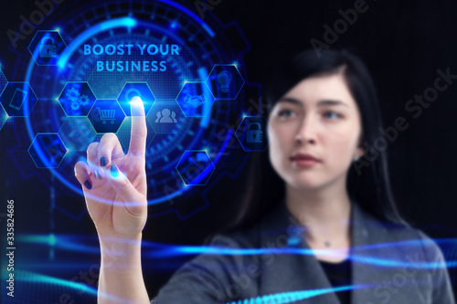 Business, Technology, Internet and network concept. Young businessman working on a virtual screen of the future and sees the inscription: Boost your business