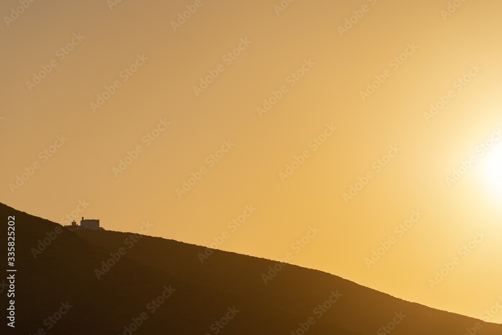 An isolated traditional house in the hills of Serifos island Cyclades Aegean Greece in golden warm light during sunset