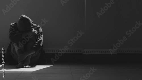 Photography Sunlight and shadow on surface of hopeless man sitting alone with hugging his kn
