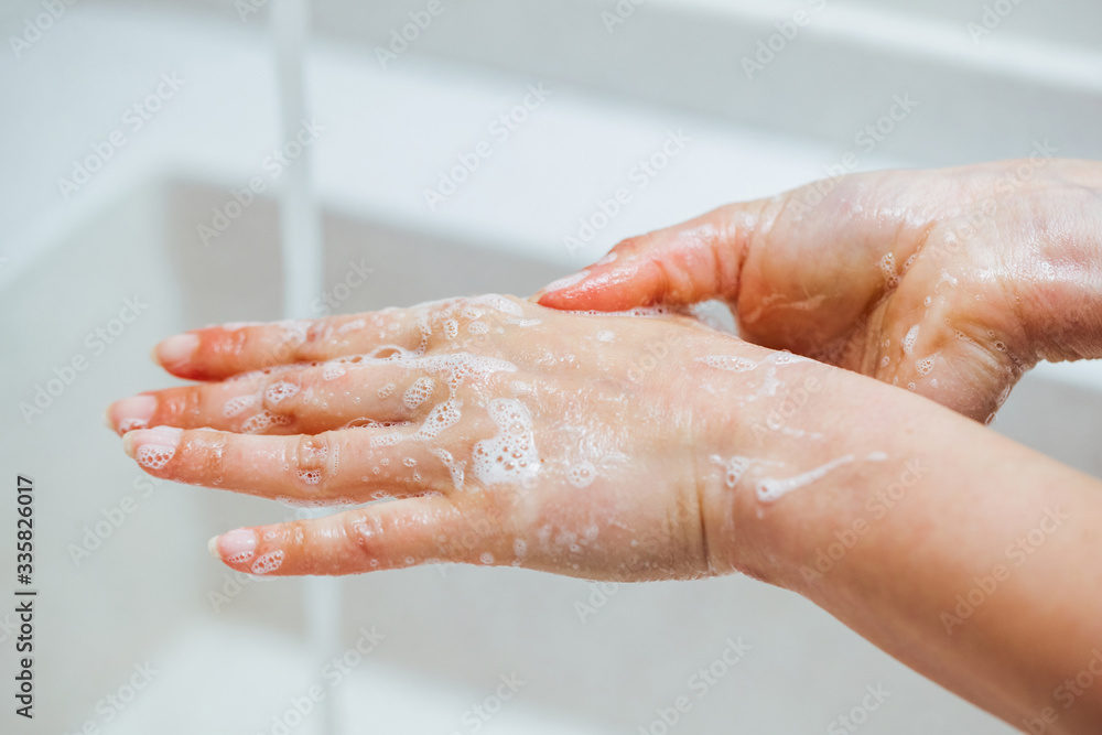 Close-up of woman washing hands with a soap. Close-up of woman washing hands with a soap.