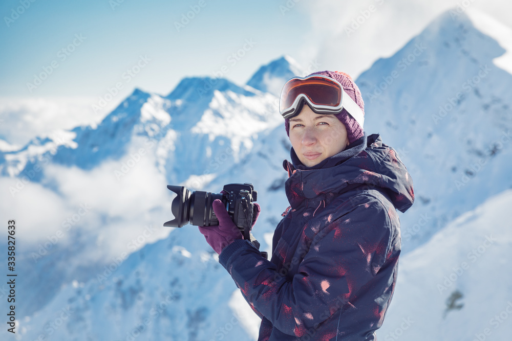 Female skier photographs in mountains