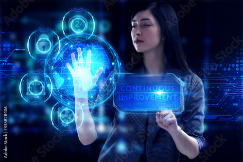 Business, Technology, Internet and network concept. Young businessman working on a virtual screen of the future and sees the inscription: Continuous improvement