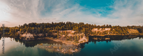 Amazing panorama of basalt columns at an altitude in western Ukraine with green lake and endless sky